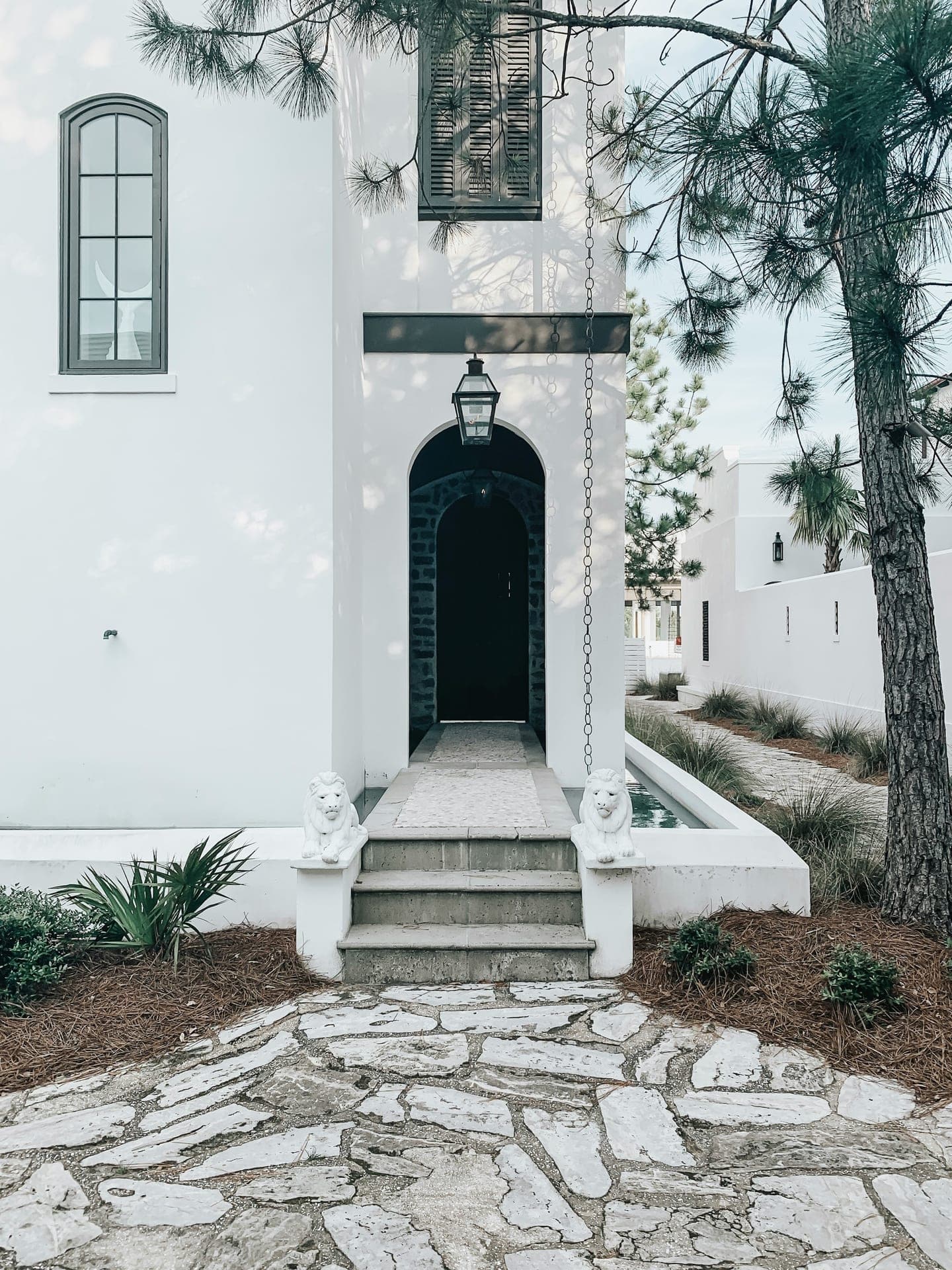 Doorway and stone path at a coastal residence on Florida's Emerald Coast.
